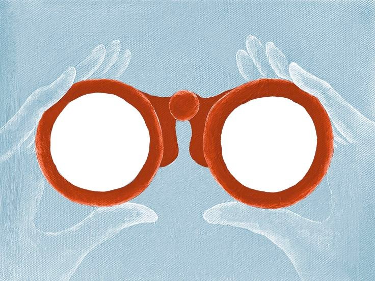 A pair of red binoculars looking through lenses